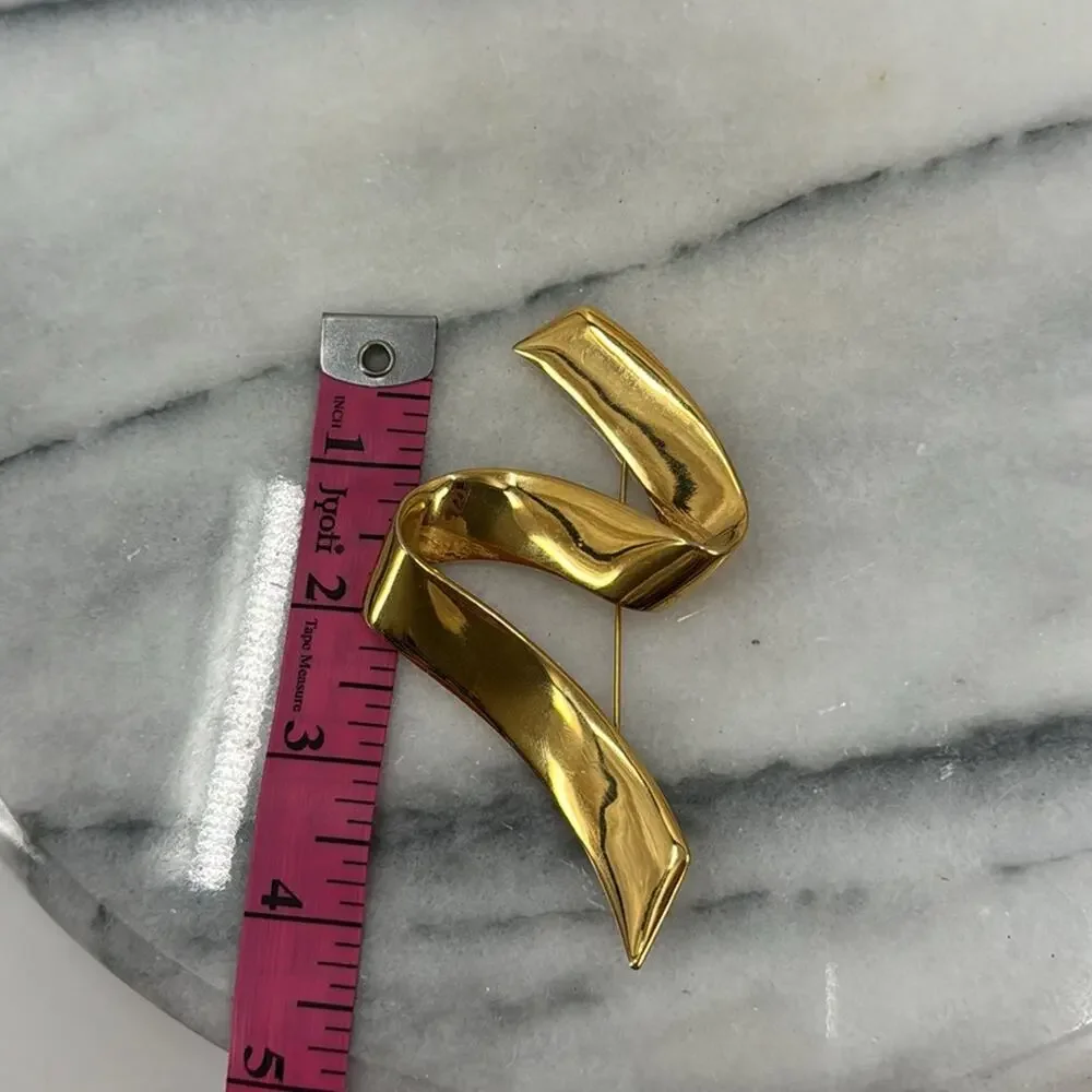 Vintage monet gold ribbon swoosh brooch